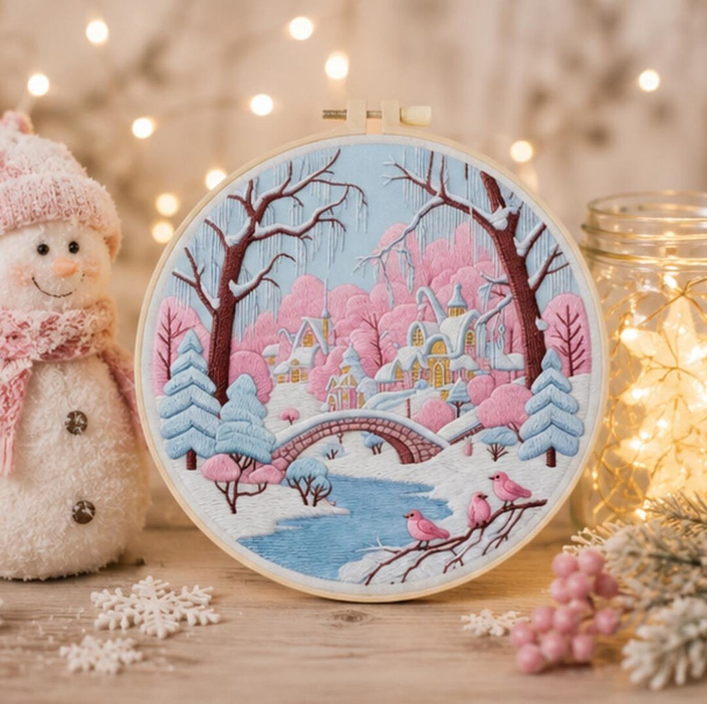 Pink winter village embroidery hoop close-up